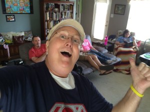 Bald man celebrating with family, they were gathered around some electrifying show...